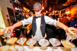 A bartender poring delicious drink in the glass